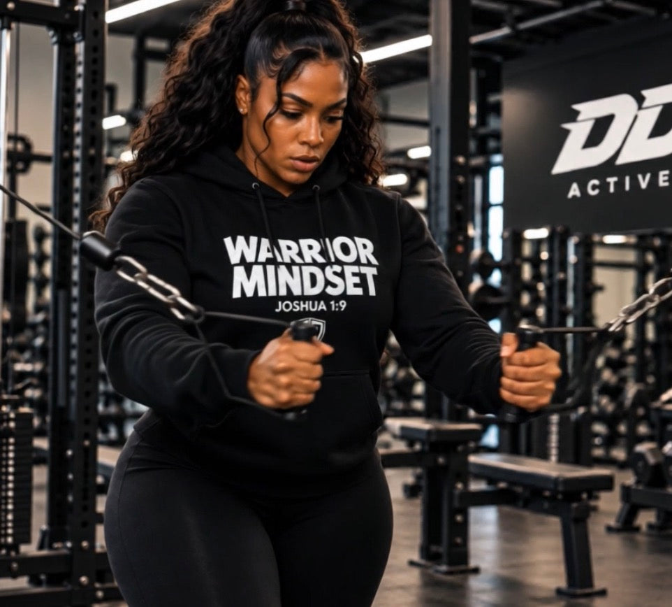 Naomi training in the DDA gym wearing the black Warrior Mindset hoodie